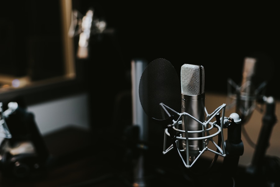 Close-up of a broadcast condenser microphone on a shock mount with pop filter